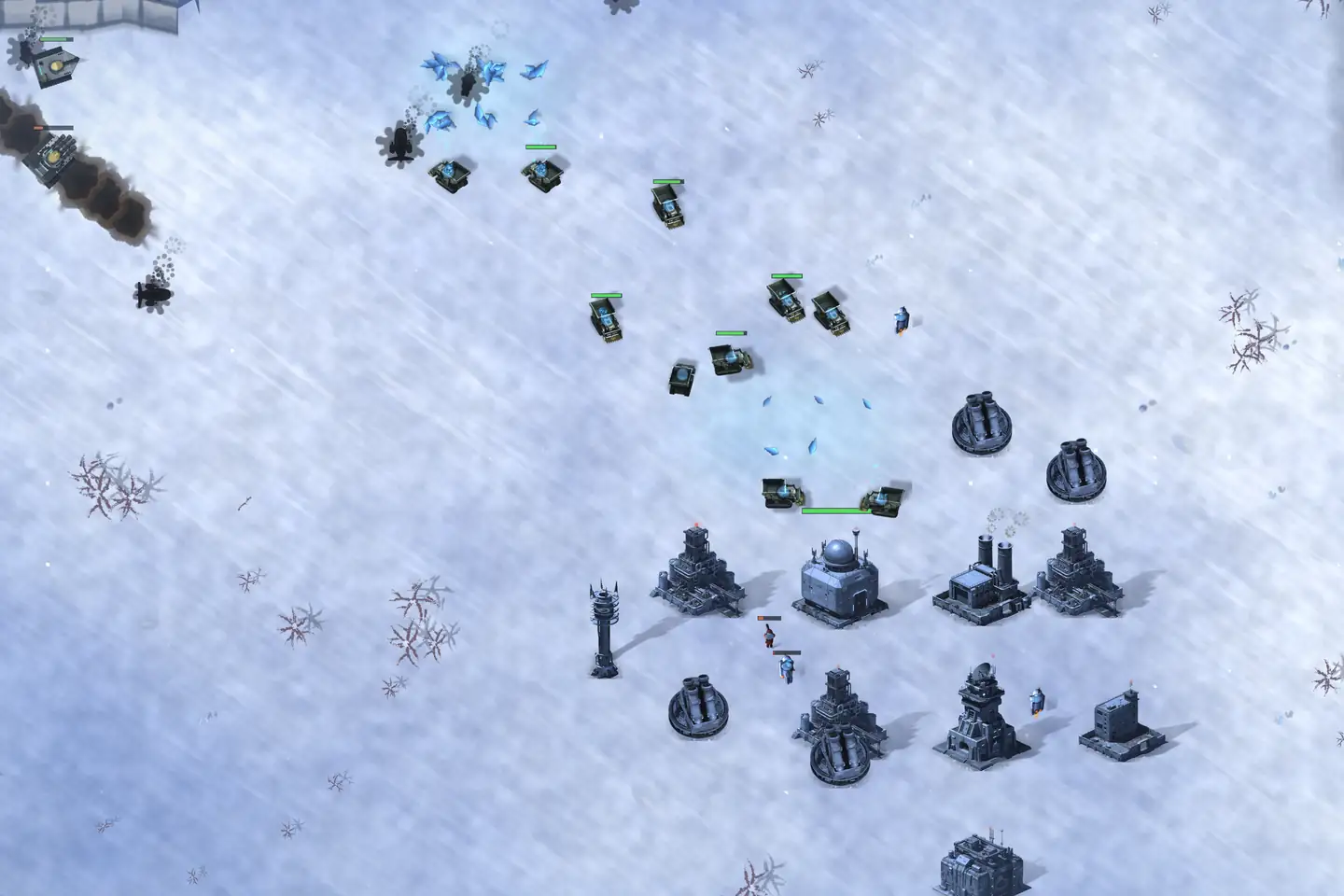 A base on a snowfield with its army above it: grey-steel buildings laid out in rows &mdash; one under a radar dome, one with two chimney stacks, a lattice mast, a low blockhouse and four squat dark gun emplacements &mdash; each throwing a long shadow. A dozen olive-marked tanks stand between the base and a patch of blue crystal ore at the centre of the frame, health bars over them. Something is burning off the top-left corner, trailing smoke.